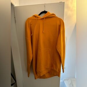 Orange sweater worn it once as a Halloween costume; dressed up as Ariana Grande